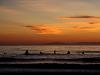 Surfers at dusk